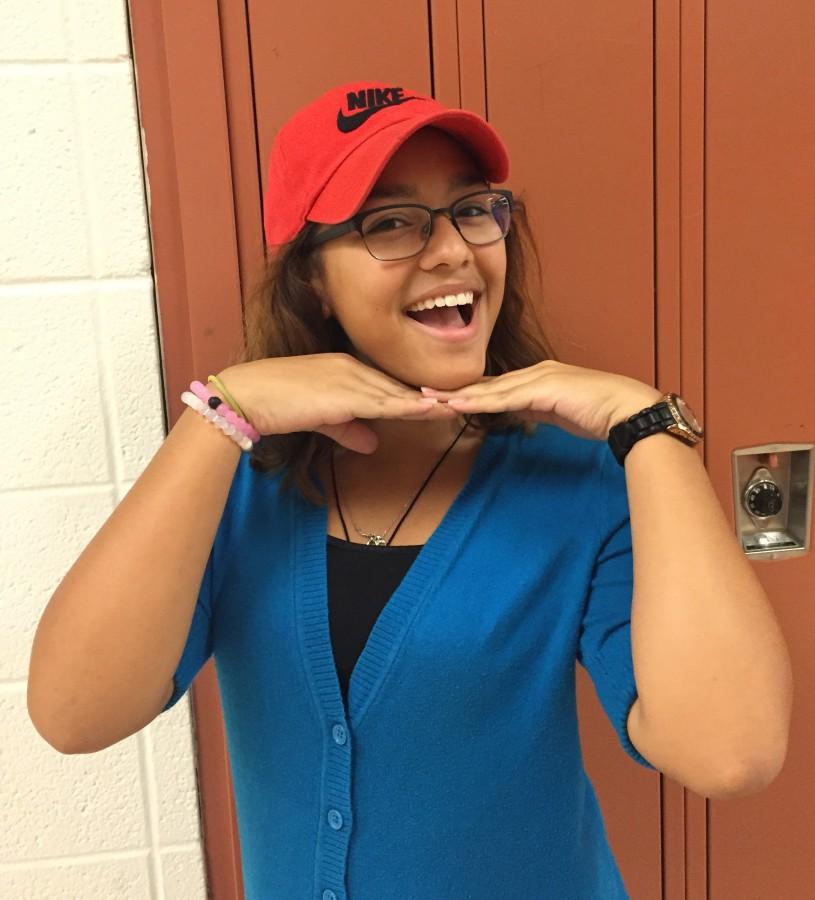 Junior Vivian Mendez Donis shows off the hat that she is now allowed to wear.