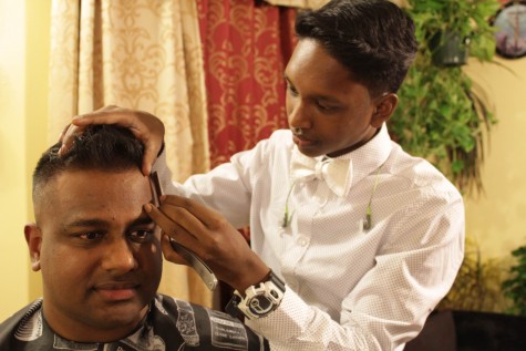 Senior Glen Gabriel lines up pilot Ravi Cherian's hairline.