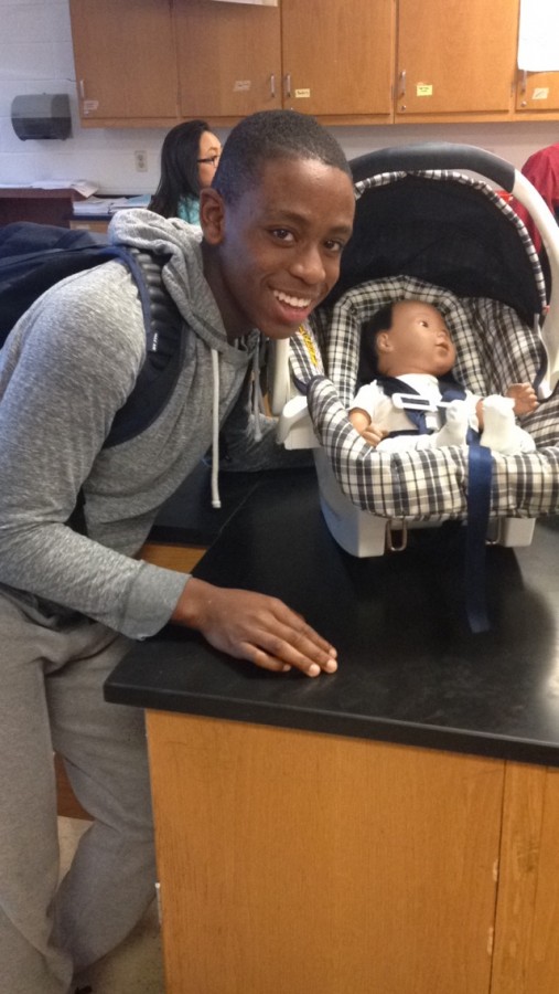 Sophomore Salekri Sayeh poses with his robotic baby that he had to parent for a day as part of his health education class.