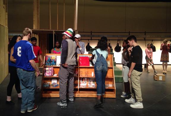 The cast of In the Heights gets into place for the shows opening number, under director Jamaly Allens instructions.