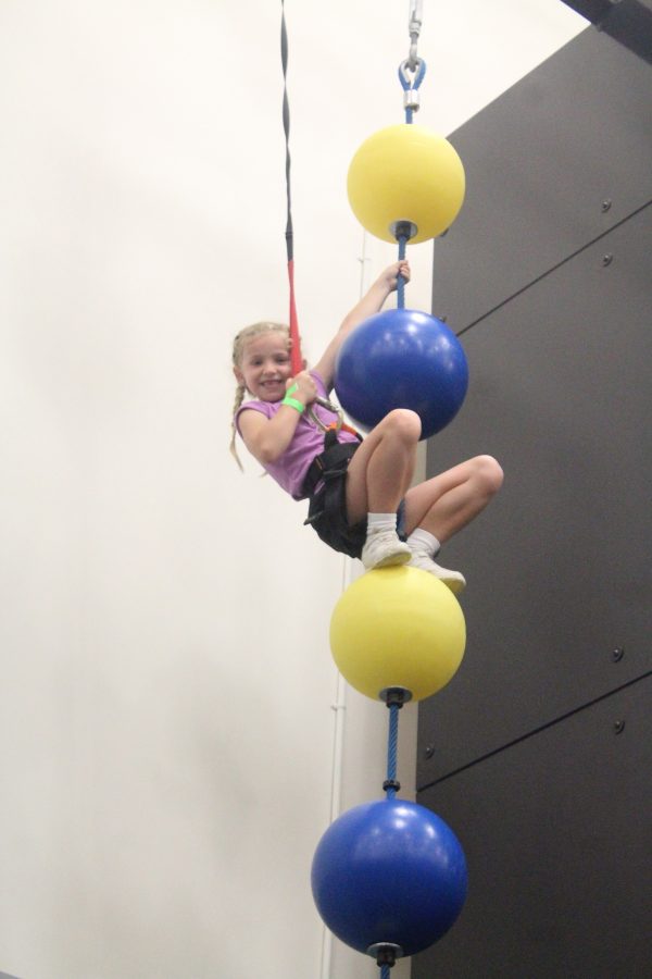 A young girl completing an obstacle in the Vertical Zone