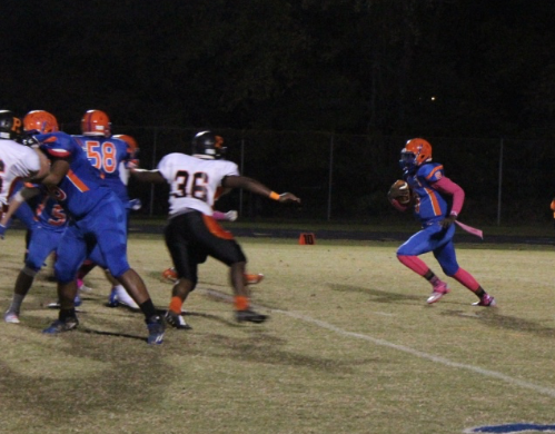 Quarterback Markel Grant runs the ball against the Rockville defense. 