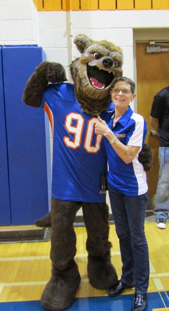 Principal Carol Goddard cheeses with the mascot.  Do you know his name?