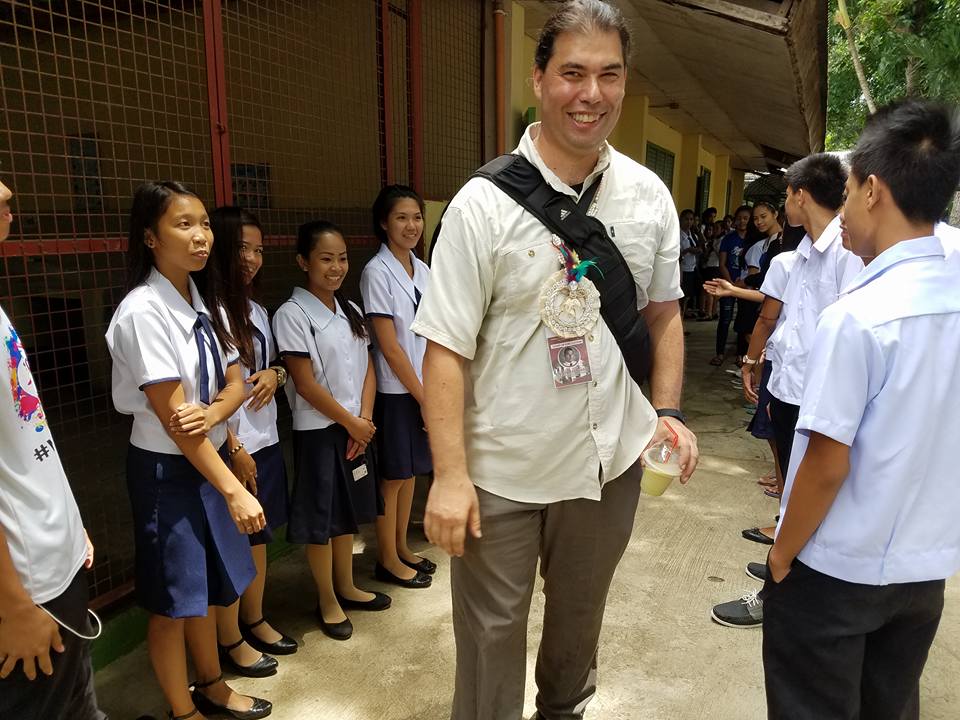 Social studies teacher Adam Schwartz with his students in the Philippines