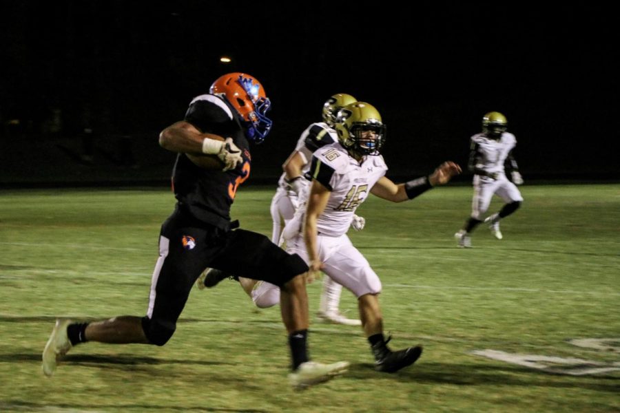 Junior running back Anthony Rush carries the ball on the outside