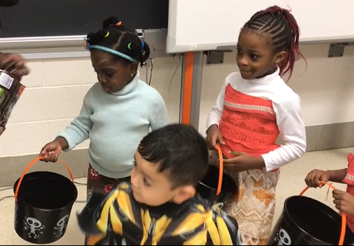 Preschool students go trick-or-treating during classes