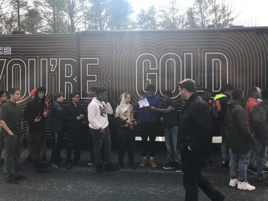 Students get ready to enter the Goldmobile