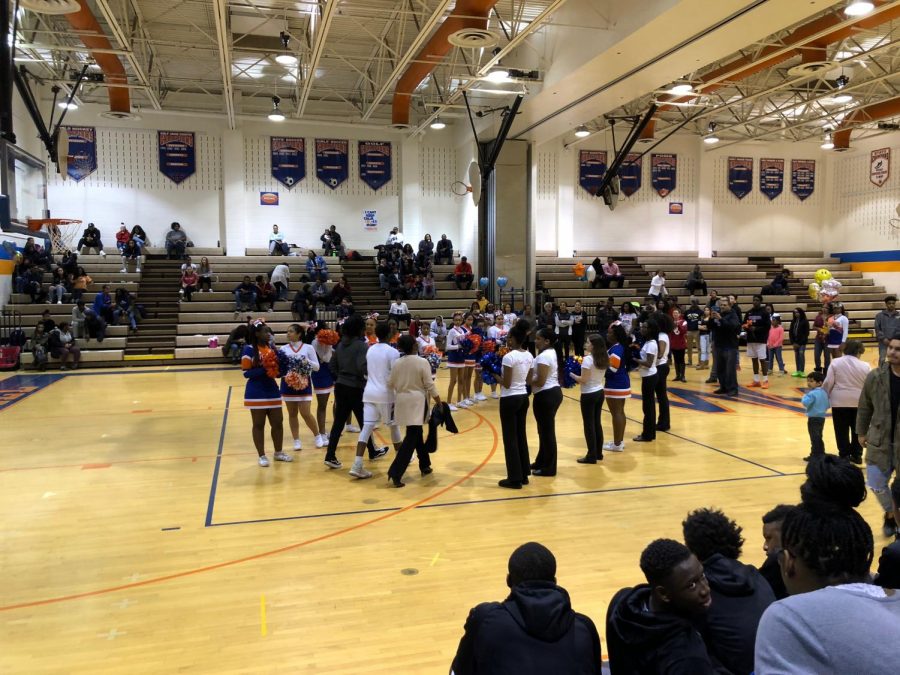 Basketball players are escorted for senior night.