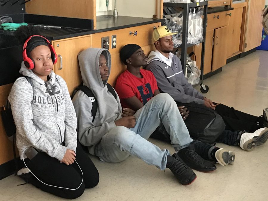 Students+sit+silently+against+the+wall+during+the+active-shooter+drill