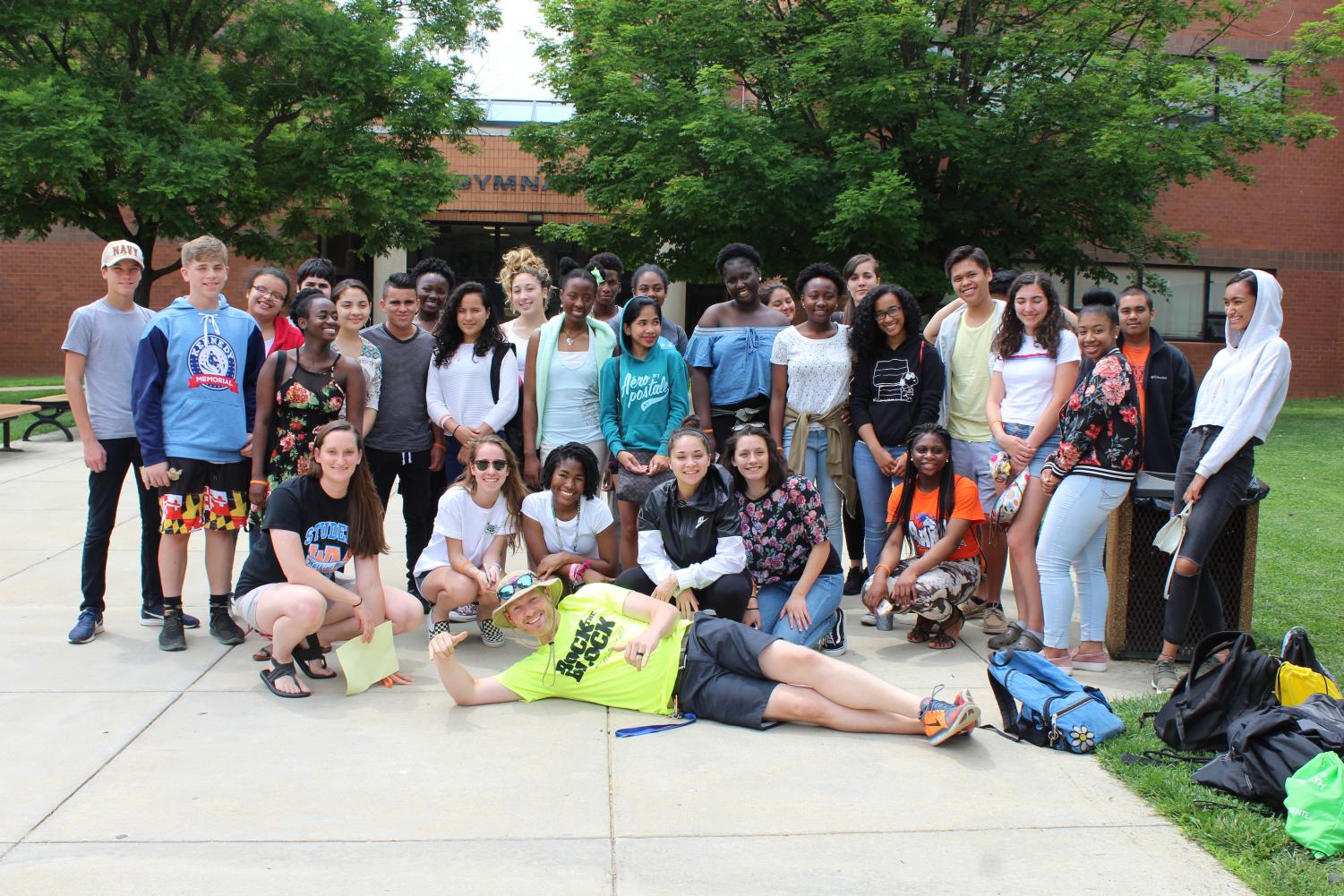 The students who got straight As all year pose in front of Watkins Mill with chaperones Lauren Squier and Matt Johnson before leaving for the National Zoo