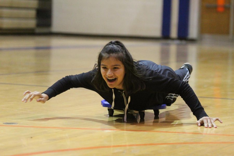 A student laughs as she races towards the finish line
