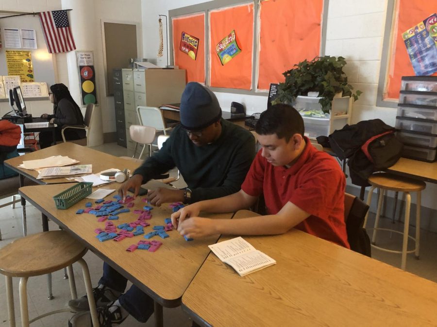 Freshman Kevin Mensah and sophomore Frank Castro practice sorting as part of the transition program to help them gain job experience for life after high school.