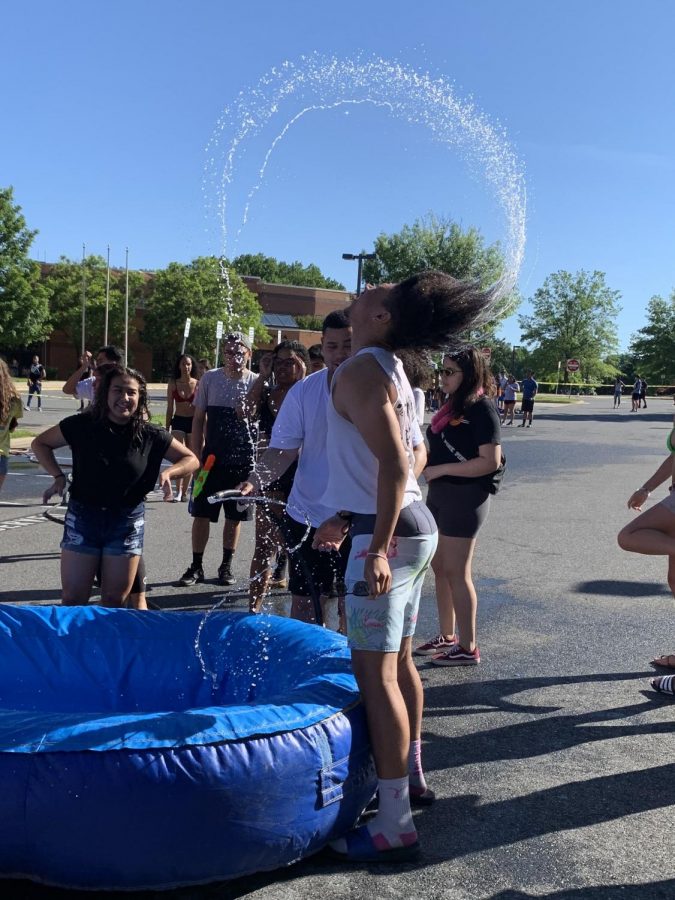 Senior Isiah Goslee flips his hair from the pool at the end of the bounce house.  Seniors celebrated their last day of school with an all-day cookout in the staff parking lot.