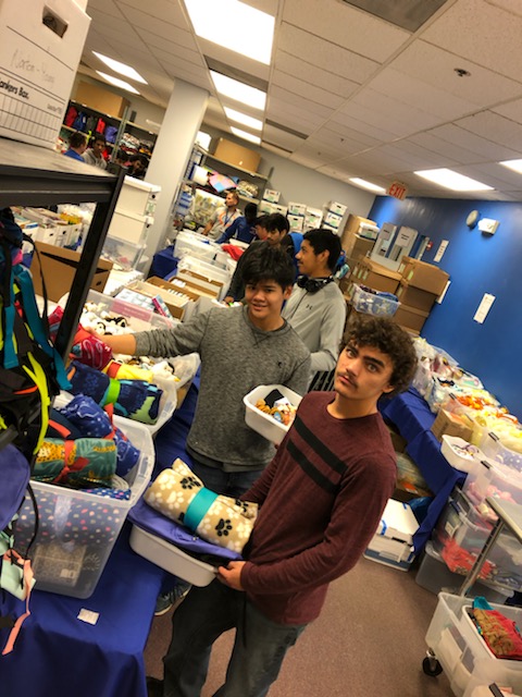 Junior Raemont Afable and senior Alex Abernethy picking supplies for their comfort backpack