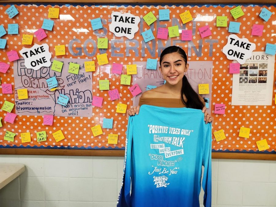 Senior Adriana Amaya stands in front of the sticky notes board in the mixing bowl. The student leadership class started putting up the positive messages as an anti-bullying campaign.