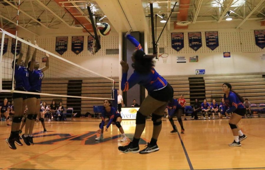 Junior Precious Fraizer hits the ball to score a point for the Watkins Mill Wolverines.
