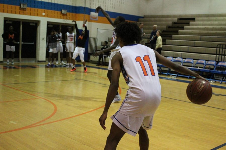 Senior Jaylen Stephens warms up for a game against Poolesville High School.