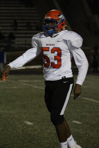 Caleb Mbulle on the football field as a Watkins Mill Wolverine.