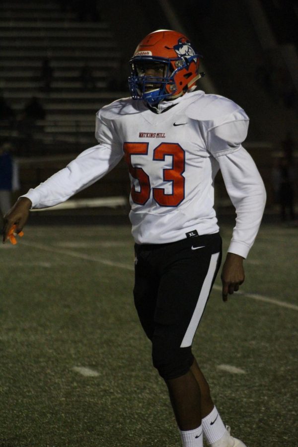 Caleb Mbulle on the football field as a Watkins Mill Wolverine.