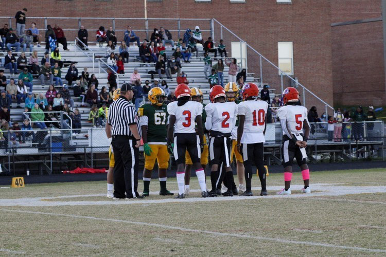 Varsity captains Muna Darlington #3, Devin Breckenridge #2, Kamarr Louissaint #10, and Brian Awisome #5 (left to right) 