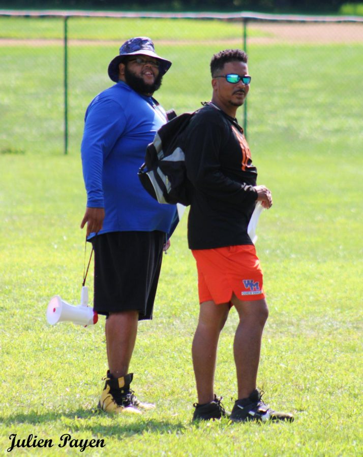 (From left to right) Coach Chad Wilson and coach Paul Vance at football practice.