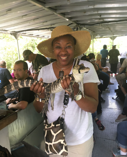 Joye Saxon holds a baby alligator. 