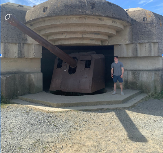 Cassini poses in front of a German casemate artillery piece from World War II, just outside of the D-Day beaches in France.