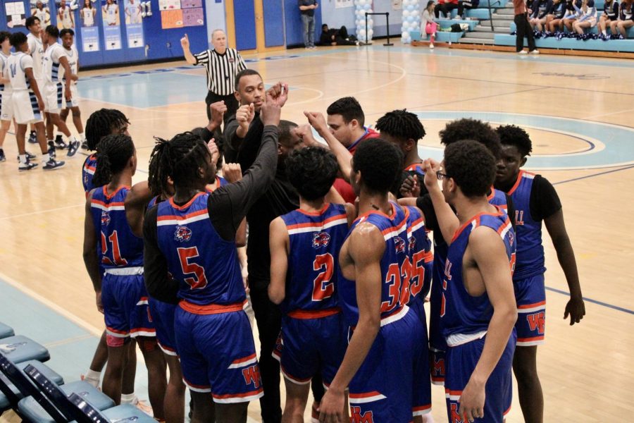 Varsity Boys Basketball held a team huddle in their game against the Clarksburg Coyotes on Tuesday, February 14.