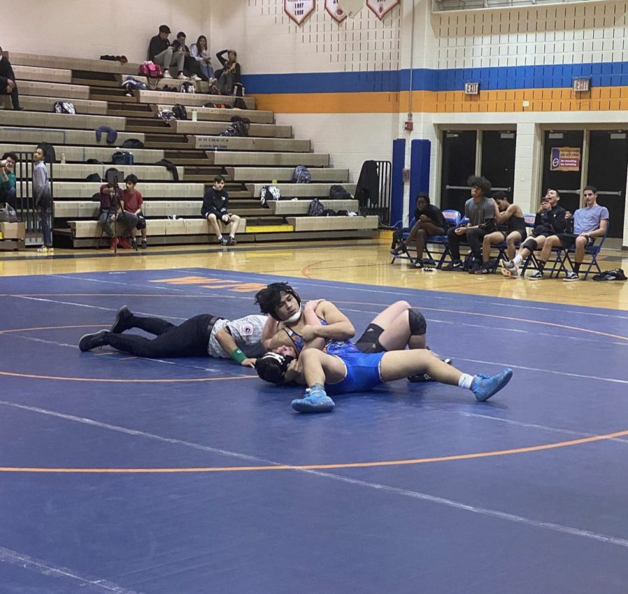Junior Raiden Siapno pins his opponent during the Rines wrestling match against the Richard Montgomery Rockets.