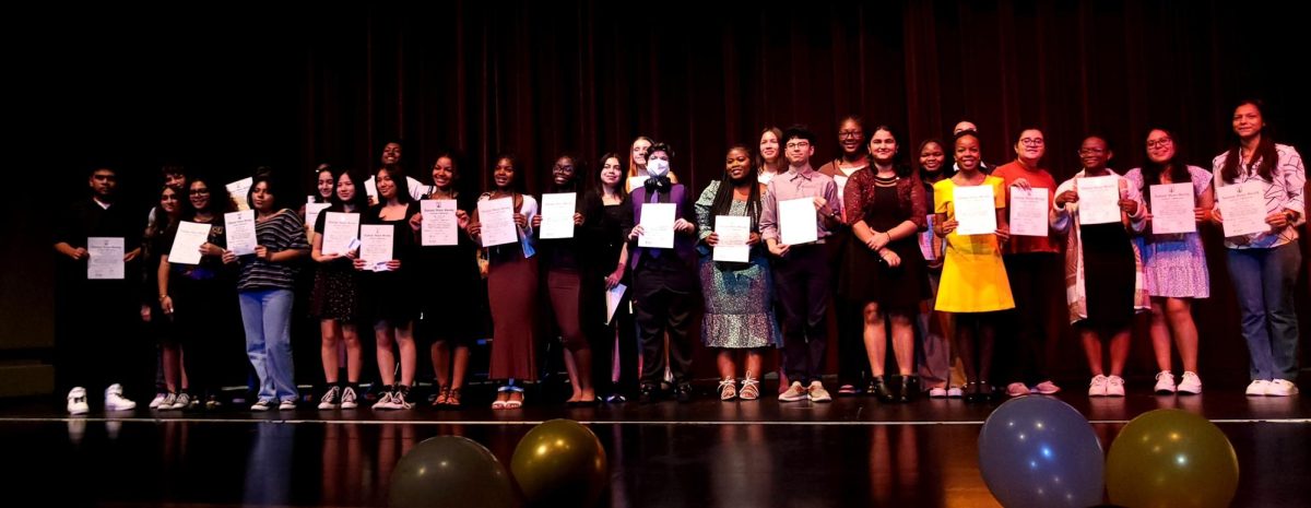 NHS Inductees gather for a group picture, holding their certificates.